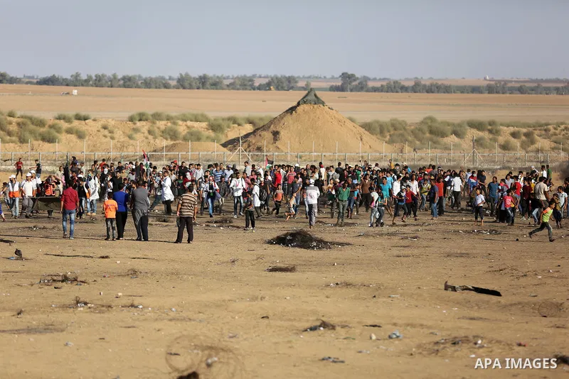 Palestinian protesters gather during clashes with Israeli troops in tents protest where Palestinians demand the right to return to their homeland at the Israel-Gaza border, in Khan Younis in the southern of Gaza Strip on...