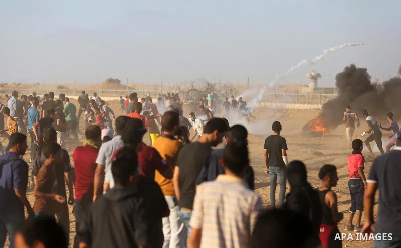 Palestinian protesters gather during clashes with Israeli troops in tents protest where Palestinians demand the right to return to their homeland at the Israel-Gaza border, in Khan Younis in the southern of Gaza Strip on...