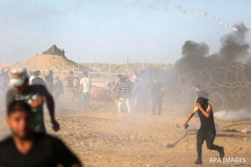 Palestinian protesters gather during clashes with Israeli troops in tents protest where Palestinians demand the right to return to their homeland at the Israel-Gaza border, in Khan Younis in the southern of Gaza Strip on...
