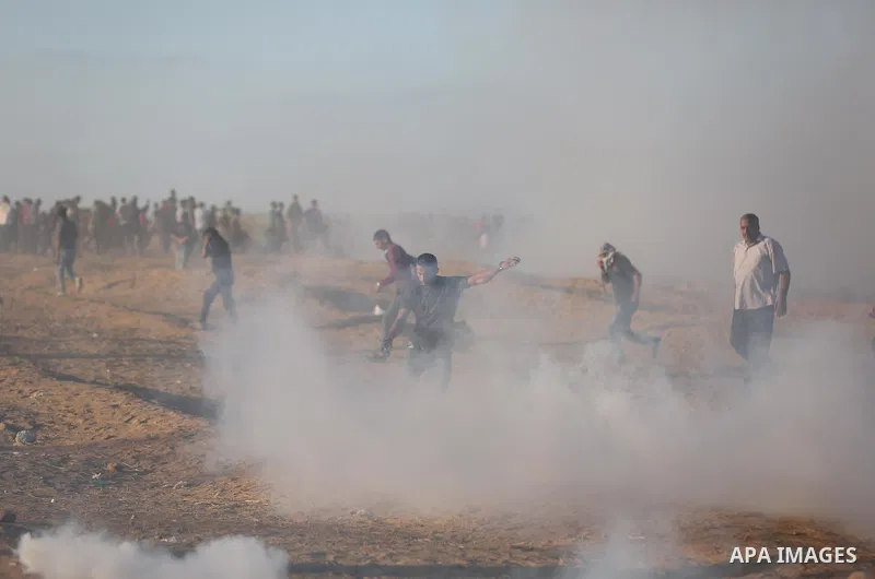 Palestinian protesters gather during clashes with Israeli troops in tents protest where Palestinians demand the right to return to their homeland at the Israel-Gaza border, in Khan Younis in the southern of Gaza Strip on...
