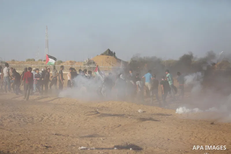 Palestinian protesters gather during clashes with Israeli troops in tents protest where Palestinians demand the right to return to their homeland at the Israel-Gaza border, in Khan Younis in the southern of Gaza Strip on...