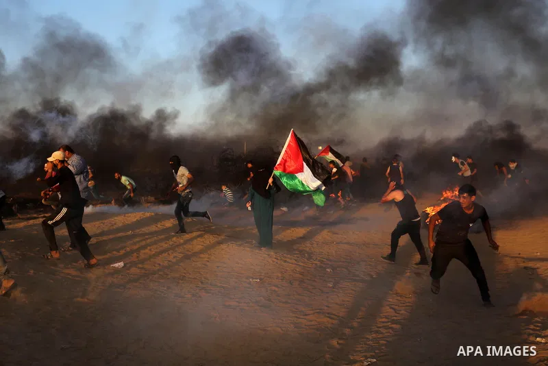 Palestinian protesters gather during clashes with Israeli troops in tents protest where Palestinians demand the right to return to their homeland at the Israel-Gaza border, in Khan Younis in the southern of Gaza Strip on...