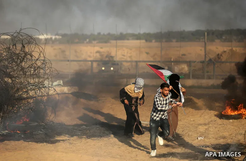 Palestinian protesters gather during clashes with Israeli troops in tents protest where Palestinians demand the right to return to their homeland at the Israel-Gaza border, in Khan Younis in the southern of Gaza Strip on...