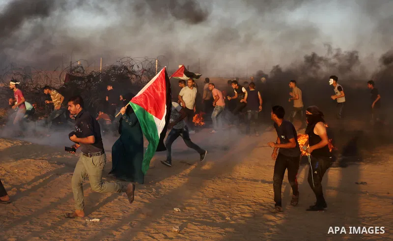 Palestinian protesters gather during clashes with Israeli troops in tents protest where Palestinians demand the right to return to their homeland at the Israel-Gaza border, in Khan Younis in the southern of Gaza Strip on...