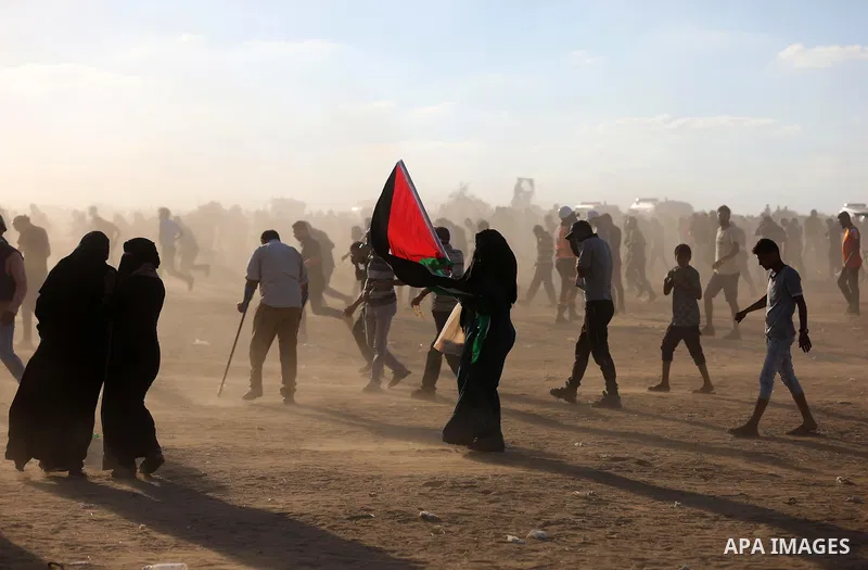 Palestinian protesters gather during clashes with Israeli troops in tents protest where Palestinians demand the right to return to their homeland at the Israel-Gaza border, in Khan Younis in the southern of Gaza Strip on...