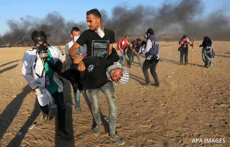 Palestinian protesters gather during clashes with Israeli troops in tents protest where Palestinians demand the right to return to their homeland at the Israel-Gaza border, in Khan Younis in the southern of Gaza Strip on...