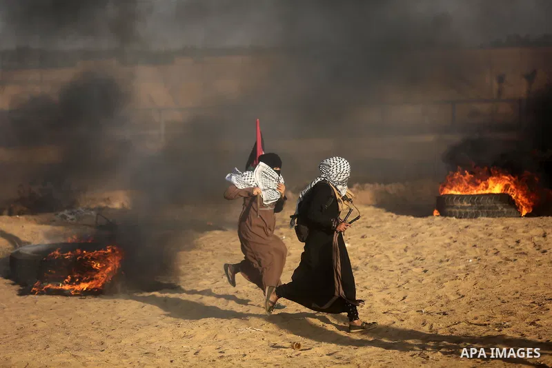 Palestinian protesters gather during clashes with Israeli troops in tents protest where Palestinians demand the right to return to their homeland at the Israel-Gaza border, in Khan Younis in the southern of Gaza Strip on...