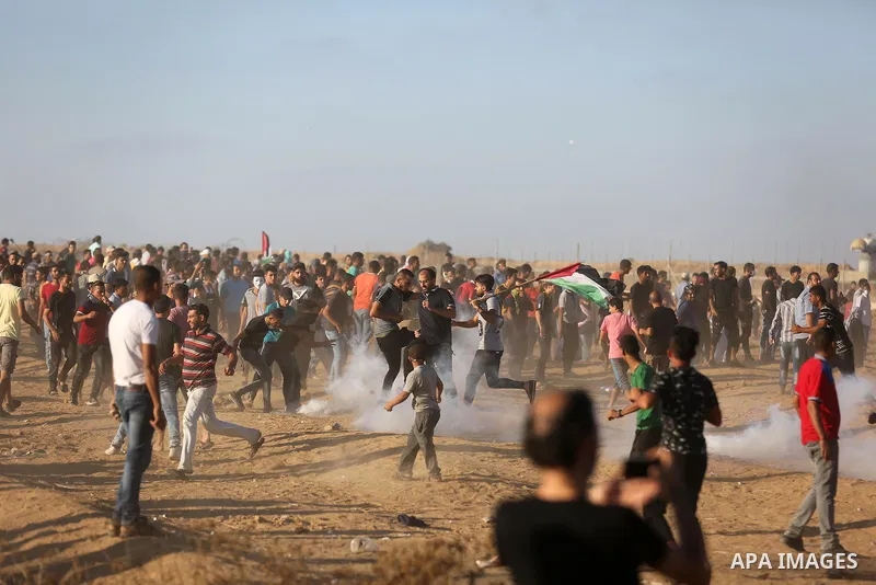 Palestinian protesters gather during clashes with Israeli troops in tents protest where Palestinians demand the right to return to their homeland at the Israel-Gaza border, in Khan Younis in the southern of Gaza Strip on...