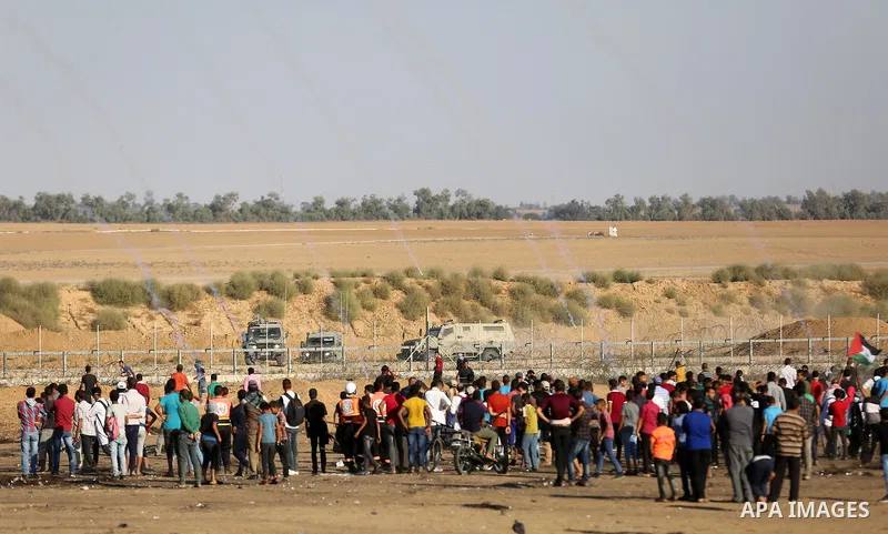 Palestinian protesters gather during clashes with Israeli troops in tents protest where Palestinians demand the right to return to their homeland at the Israel-Gaza border, in Khan Younis in the southern of Gaza Strip on...