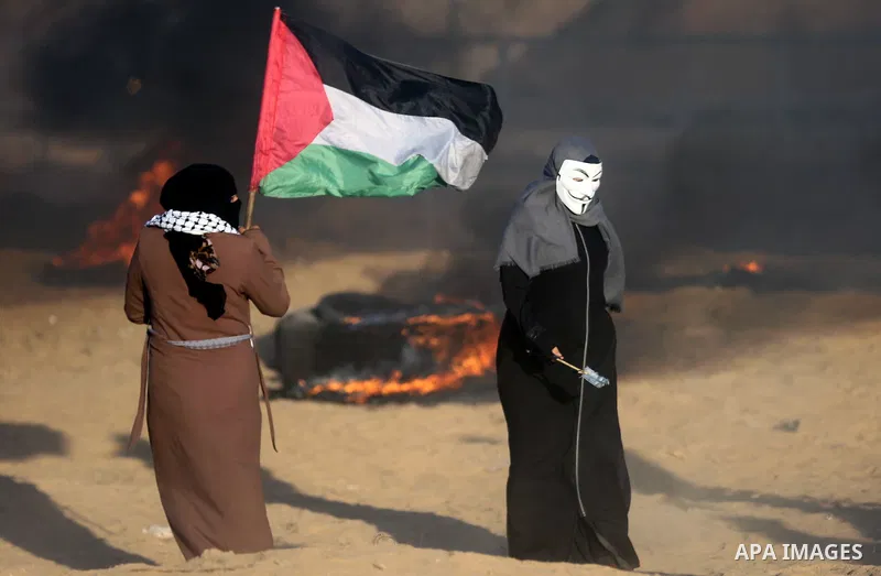 Palestinian protesters gather during clashes with Israeli troops in tents protest where Palestinians demand the right to return to their homeland at the Israel-Gaza border, in Khan Younis in the southern of Gaza Strip on...