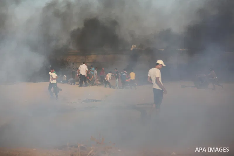 Palestinian protesters gather during clashes with Israeli troops in tents protest where Palestinians demand the right to return to their homeland at the Israel-Gaza border, in Khan Younis in the southern of Gaza Strip on...