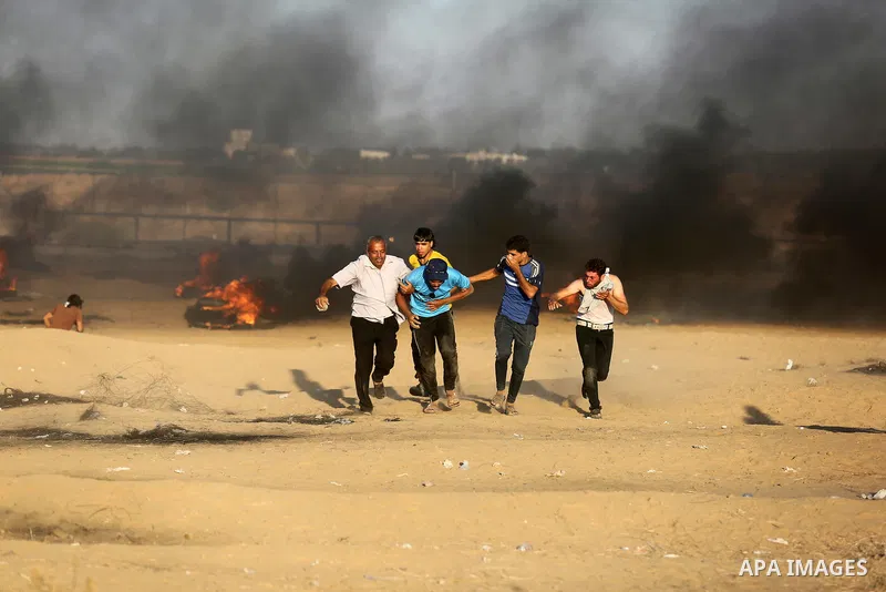 Palestinian protesters gather during clashes with Israeli troops in tents protest where Palestinians demand the right to return to their homeland at the Israel-Gaza border, in Khan Younis in the southern of Gaza Strip on...