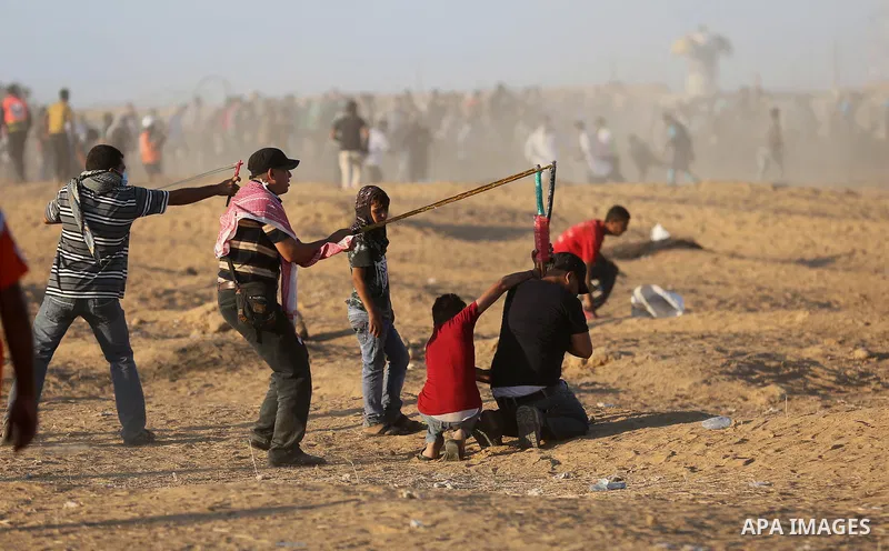 Palestinian protesters gather during clashes with Israeli troops in tents protest where Palestinians demand the right to return to their homeland at the Israel-Gaza border, in Khan Younis in the southern of Gaza Strip on...