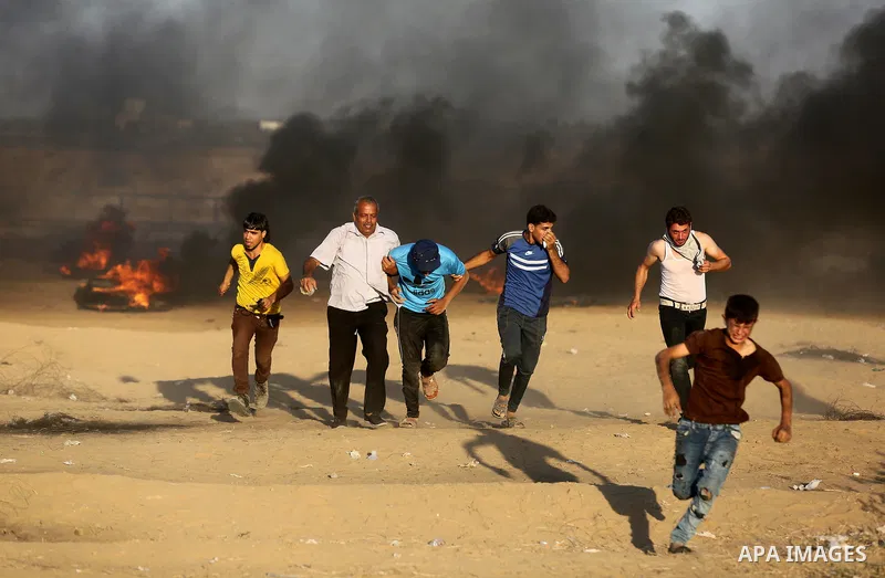 Palestinian protesters gather during clashes with Israeli troops in tents protest where Palestinians demand the right to return to their homeland at the Israel-Gaza border, in Khan Younis in the southern of Gaza Strip on...
