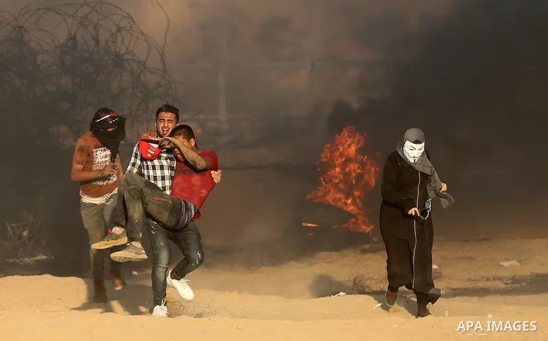 Palestinian protesters gather during clashes with Israeli troops in tents protest where Palestinians demand the right to return to their homeland at the Israel-Gaza border, in Khan Younis in the southern of Gaza Strip on...