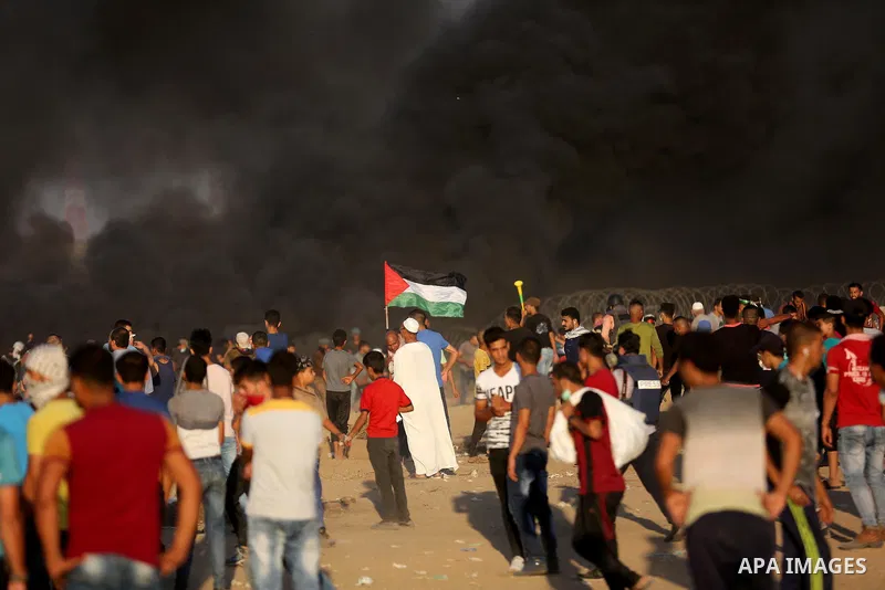 Palestinian protesters gather during clashes with Israeli troops in tents protest where Palestinians demand the right to return to their homeland at the Israel-Gaza border, in Khan Younis in the southern of Gaza Strip on...