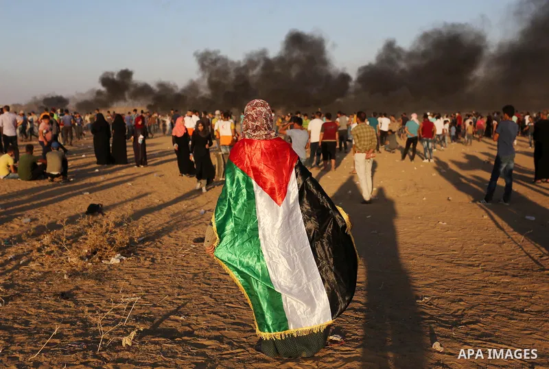 Palestinian protesters gather during clashes with Israeli troops in tents protest where Palestinians demand the right to return to their homeland at the Israel-Gaza border, in Khan Younis in the southern of Gaza Strip on...