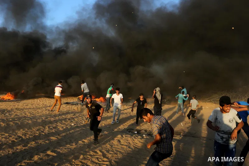 Palestinian protesters gather during clashes with Israeli troops in tents protest where Palestinians demand the right to return to their homeland at the Israel-Gaza border, in Khan Younis in the southern of Gaza Strip on...