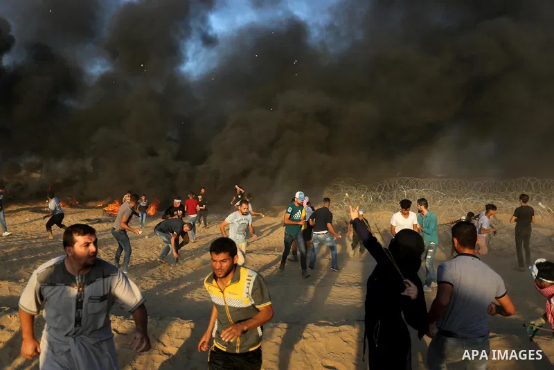 Palestinian protesters gather during clashes with Israeli troops in tents protest where Palestinians demand the right to return to their homeland at the Israel-Gaza border, in Khan Younis in the southern of Gaza Strip on...
