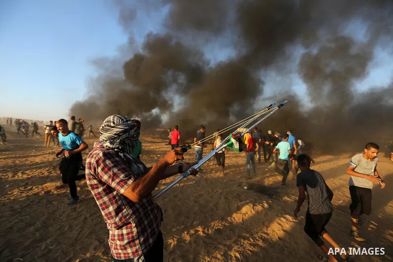 Palestinian protesters gather during clashes with Israeli troops in tents protest where Palestinians demand the right to return to their homeland at the Israel-Gaza border, in Khan Younis in the southern of Gaza Strip on...