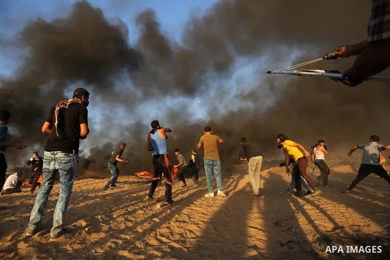 Palestinian protesters gather during clashes with Israeli troops in tents protest where Palestinians demand the right to return to their homeland at the Israel-Gaza border, in Khan Younis in the southern of Gaza Strip on...