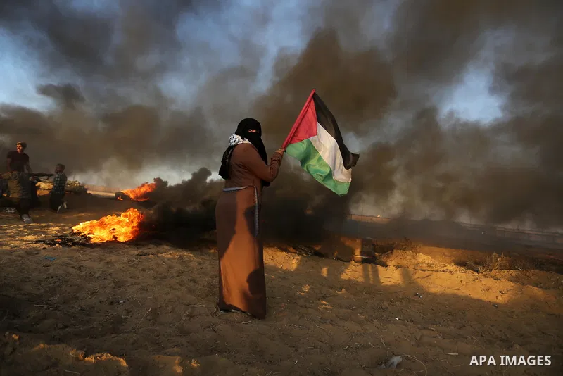 Palestinian protesters gather during clashes with Israeli troops in tents protest where Palestinians demand the right to return to their homeland at the Israel-Gaza border, in Khan Younis in the southern of Gaza Strip on...
