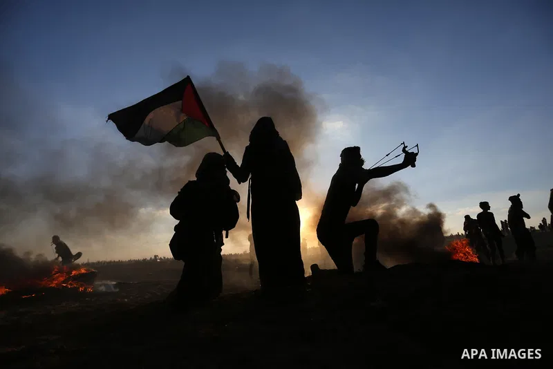 Palestinian protesters gather during clashes with Israeli troops in tents protest where Palestinians demand the right to return to their homeland at the Israel-Gaza border, in Khan Younis in the southern of Gaza Strip on...