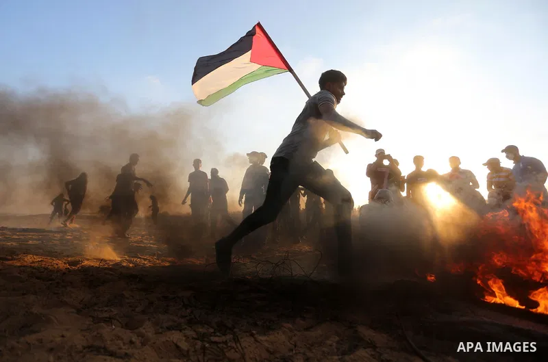 Palestinian protesters gather during clashes with Israeli troops in tents protest where Palestinians demand the right to return to their homeland at the Israel-Gaza border, in Khan Younis in the southern of Gaza Strip on...