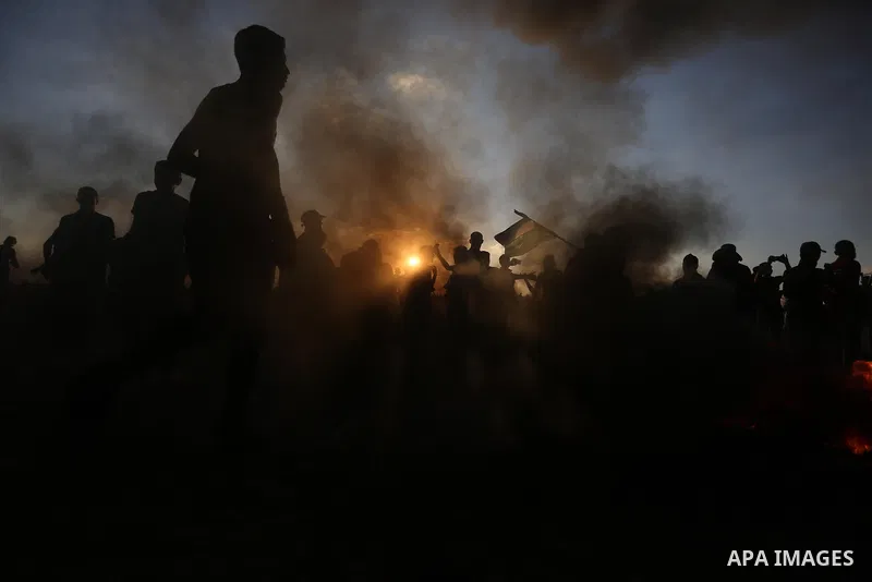 Palestinian protesters gather during clashes with Israeli troops in tents protest where Palestinians demand the right to return to their homeland at the Israel-Gaza border, in Khan Younis in the southern of Gaza Strip on...