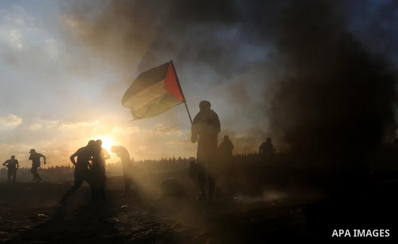 Palestinian protesters gather during clashes with Israeli troops in tents protest where Palestinians demand the right to return to their homeland at the Israel-Gaza border, in Khan Younis in the southern of Gaza Strip on...