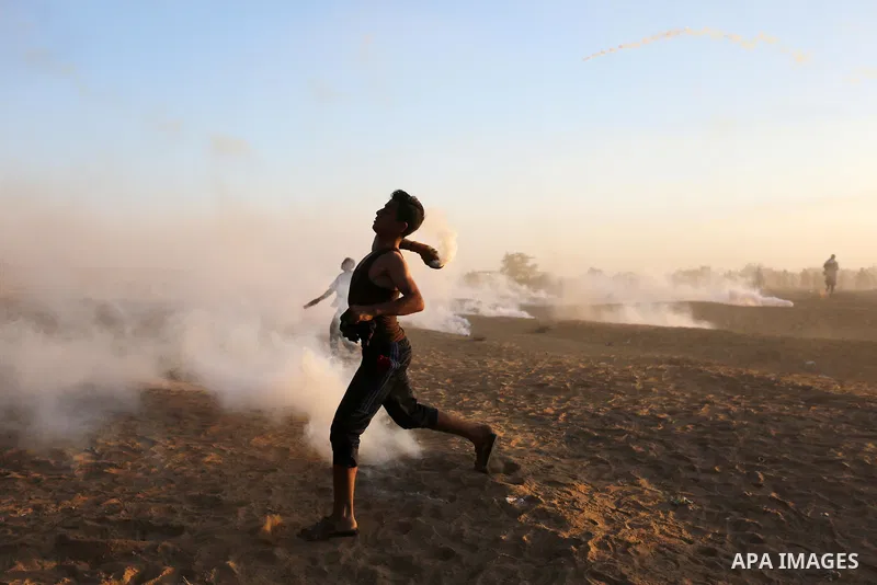 Palestinian protesters gather during clashes with Israeli troops in tents protest where Palestinians demand the right to return to their homeland at the Israel-Gaza border, in Khan Younis in the southern of Gaza Strip on...