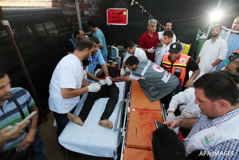 Wounded Palestinian protesters receive treatment in a medical tent during clashes with Israeli troops in tents protest where Palestinians demand the right to return to their homeland at the Israel-Gaza border, in Khan Yo...