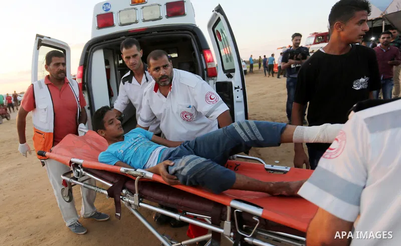 Wounded Palestinian protesters receive treatment in a medical tent during clashes with Israeli troops in tents protest where Palestinians demand the right to return to their homeland at the Israel-Gaza border, in Khan Yo...