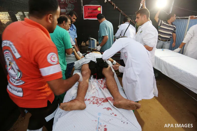Wounded Palestinian protesters receive treatment in a medical tent during clashes with Israeli troops in tents protest where Palestinians demand the right to return to their homeland at the Israel-Gaza border, in Khan Yo...