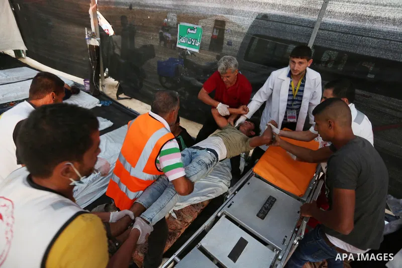 Wounded Palestinian protesters receive treatment in a medical tent during clashes with Israeli troops in tents protest where Palestinians demand the right to return to their homeland at the Israel-Gaza border, in Khan Yo...