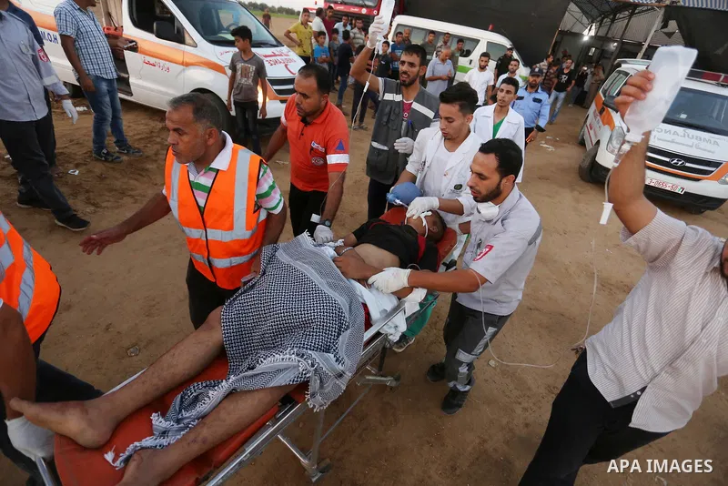 Wounded Palestinian protesters receive treatment in a medical tent during clashes with Israeli troops in tents protest where Palestinians demand the right to return to their homeland at the Israel-Gaza border, in Khan Yo...
