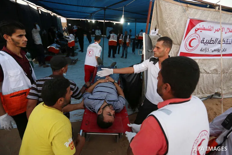 Wounded Palestinian protesters receive treatment in a medical tent during clashes with Israeli troops in tents protest where Palestinians demand the right to return to their homeland at the Israel-Gaza border, in Khan Yo...