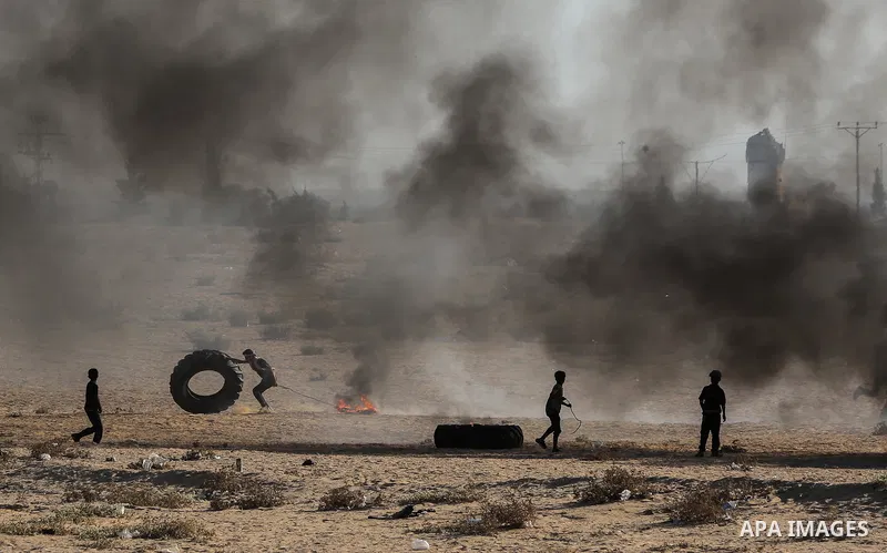 Palestinian protesters gather during clashes with Israeli troops in tents protest where Palestinians demand the right to return to their homeland at the Israel-Gaza border, in Rafah in the southern of Gaza Strip on Septe...