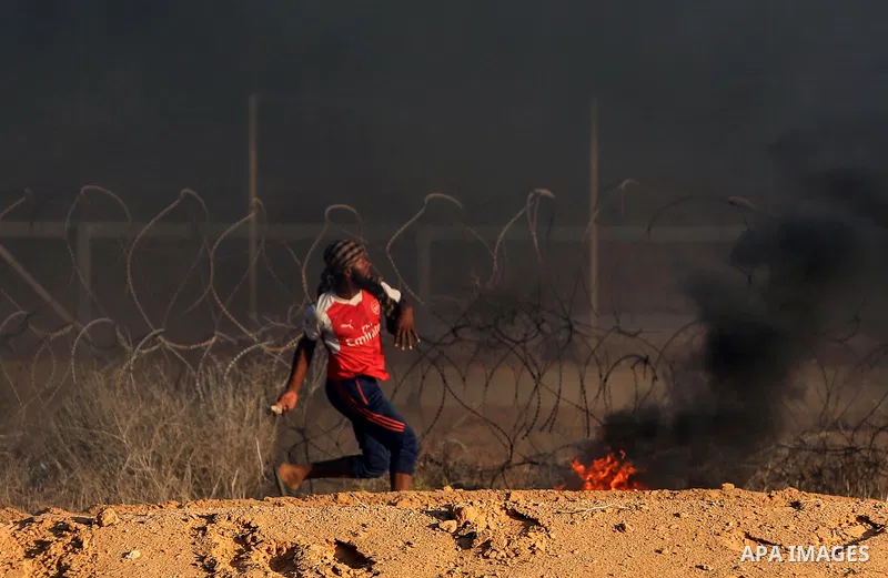 Palestinian protesters gather during clashes with Israeli troops in tents protest where Palestinians demand the right to return to their homeland at the Israel-Gaza border, in Rafah in the southern of Gaza Strip on Septe...