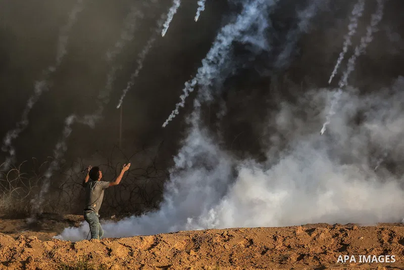 Palestinian protesters gather during clashes with Israeli troops in tents protest where Palestinians demand the right to return to their homeland at the Israel-Gaza border, in Rafah in the southern of Gaza Strip on Septe...