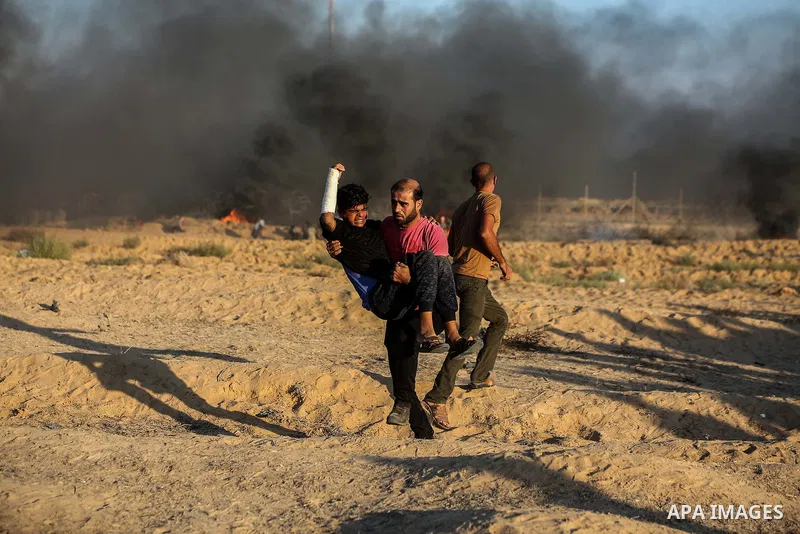 Palestinian protesters gather during clashes with Israeli troops in tents protest where Palestinians demand the right to return to their homeland at the Israel-Gaza border, in Rafah in the southern of Gaza Strip on Septe...