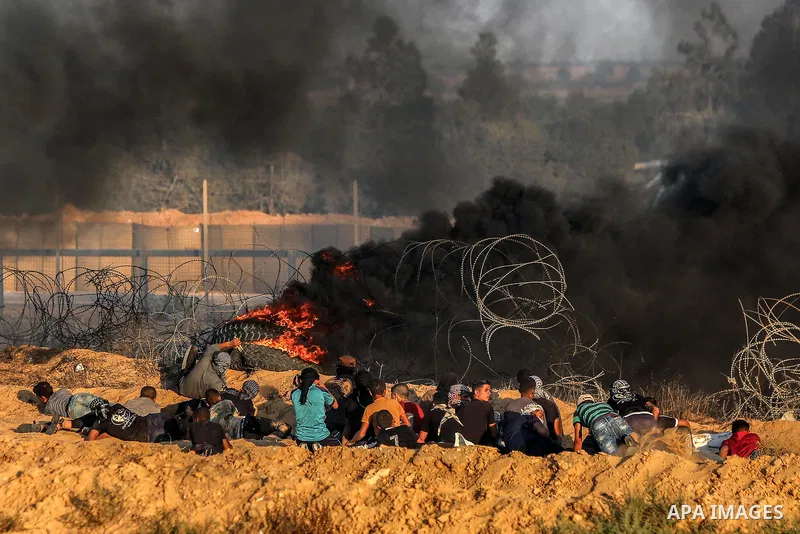 Palestinian protesters gather during clashes with Israeli troops in tents protest where Palestinians demand the right to return to their homeland at the Israel-Gaza border, in Rafah in the southern of Gaza Strip on Septe...