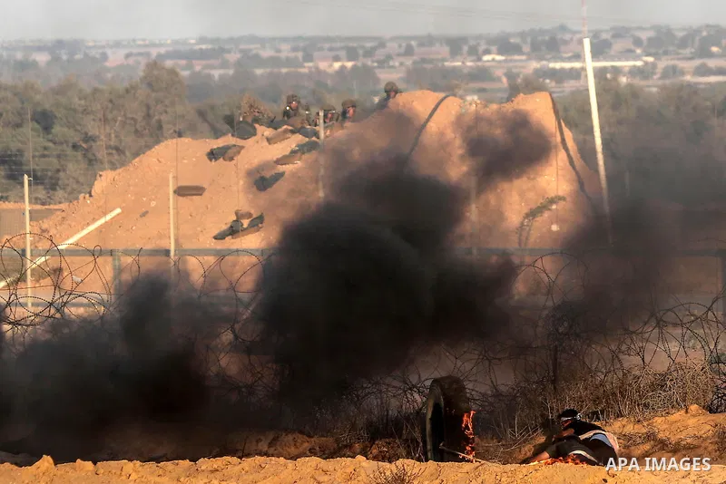 Palestinian protesters gather during clashes with Israeli troops in tents protest where Palestinians demand the right to return to their homeland at the Israel-Gaza border, in Rafah in the southern of Gaza Strip on Septe...