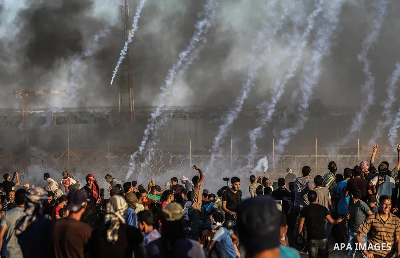 Palestinian protesters gather during clashes with Israeli troops in tents protest where Palestinians demand the right to return to their homeland at the Israel-Gaza border, in Rafah in the southern of Gaza Strip on Septe...