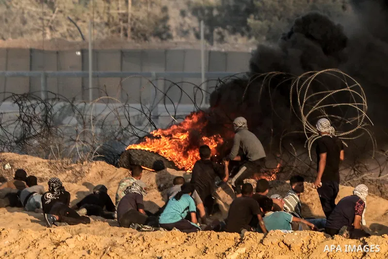 Palestinian protesters gather during clashes with Israeli troops in tents protest where Palestinians demand the right to return to their homeland at the Israel-Gaza border, in Rafah in the southern of Gaza Strip on Septe...