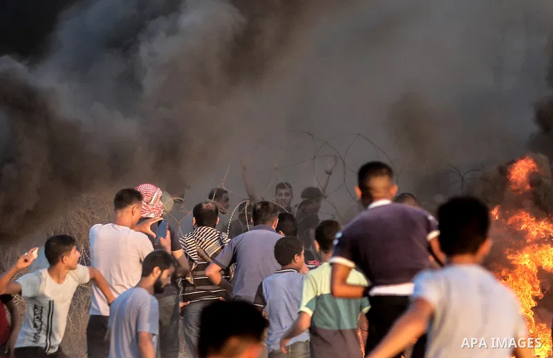 Palestinian protesters gather during clashes with Israeli troops in tents protest where Palestinians demand the right to return to their homeland at the Israel-Gaza border, in Rafah in the southern of Gaza Strip on Septe...