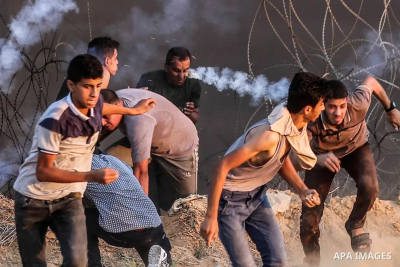 Palestinian protesters gather during clashes with Israeli troops in tents protest where Palestinians demand the right to return to their homeland at the Israel-Gaza border, in Rafah in the southern of Gaza Strip on Septe...