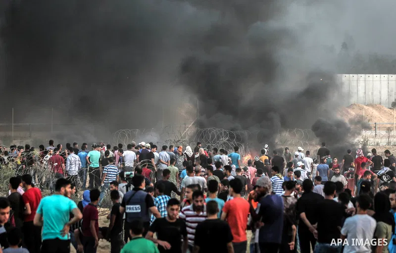 Palestinian protesters gather during clashes with Israeli troops in tents protest where Palestinians demand the right to return to their homeland at the Israel-Gaza border, in Rafah in the southern of Gaza Strip on Septe...