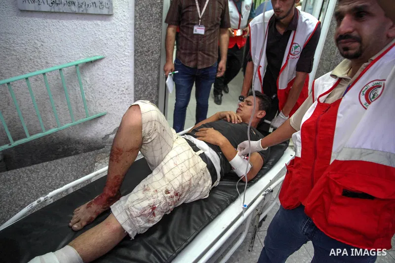 A Palestinian man who was wounded by Israeli troops during clashes at the Israel-Gaza border, in a tent city protest where Palestinians demand the right to return to their homeland, receives treatment at a hospital, in t...