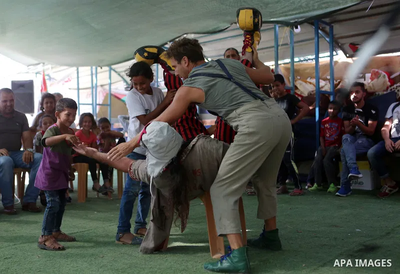 Spanish clowns perform a show in a protest tent the Palestinian Bedouin village of Khan al-Ahmar, in the occupied West Bank against Israel's plan to demolish the village on September 22, 2018. Photo by Shadi Hatem